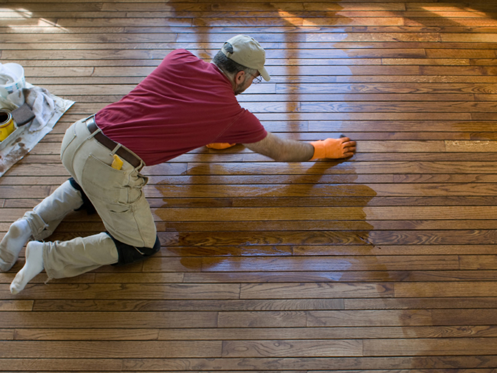 a loveland floor refinisher hard at work updating a wood floor.
